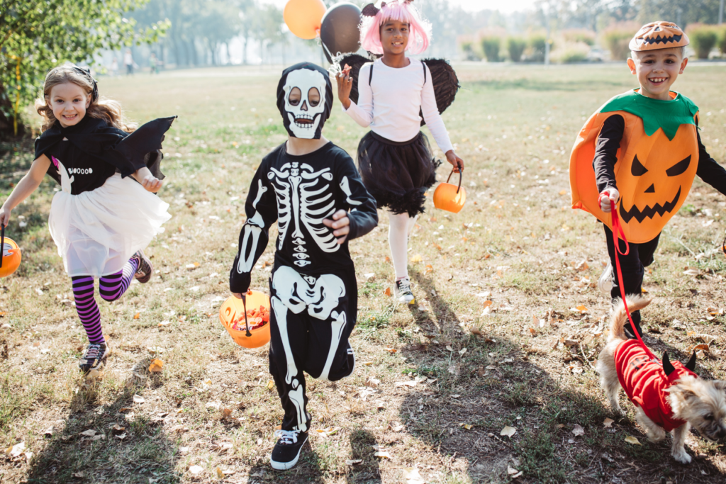 four children dressed up in halloween costumes
